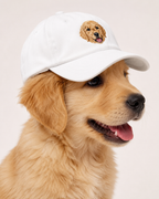White cap embroidered with a golden retriever portrait, three-quarter view