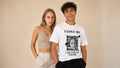 A couple standing together; the man wears the white eragoya t-shirt printed with I LOVE MY, five repeats of the word Beautiful, a cut-out portrait and GIRLFRIEND above the name Sophie.